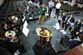 Musician Gavin Green (green top), from the Brigade of Guards, instructs the Saddleworth School Brass Xplosion band.