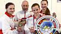 GOLD GLORY . . . Tiree Conway (left), Leah Ellerby and Amelia Gregory with Grand Master Kevin Lloyd. Not pictured: Irena Krcmarova. 