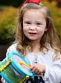 Whit Friday brass band contest at Grotton. Polly Hallas, aged 4, from Oldham, beats her drum to the music.