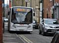 NO room for manoeuvre . . . a bus mounts the curb to squeeze past