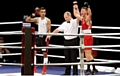 Moment of glory . . . Oldham Boxing's Will Cawley (right) celebrates his brilliant victory in Liverpool.