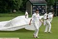 Greenfield v Rochdale, cricket match at Greenfield, Heavy rain dogged the start and play of the match. Players pull over the rain covers.