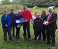 PICTURED are Oldham Mountain Rescue Team leader Mick Nield (on the left) and Jim Upton, senior deputy head teacher at Crompton House School, with pupils.
