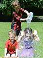 SPLASH . . . Alfie Hibbert and his cousin Niamh Palmer get a shower by Alfie's brother Charlie
