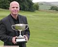 HAT-TRICK . . . Kris Sutcliffe shows off the Oldham and District Championship trophy