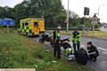 Motorcycle involved in RTA at Elk Mill roundabout, Oldham. Paramedics attend to injured rider.