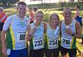 BIG SMILES . . . first two Royton female finishers Jen Bloor (234) and Kirsty White (233) celebrate with fellow team members Lee Higginbottom (98) and Ian Dale (210) at the Rochdale 10k road event
