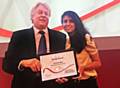 HEAD Kevin Sartain receives a certificate from Konnie Huq