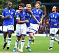 SMILES ALL ROUND . . . Ryan Flynn (left) and Paul Green show their delight after Athletic take the lead at Gigg Lane