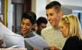 ALL SMILES . . . Prinesh Mistry and Ben Taylor receive their results from staff at Hulme Grammar School