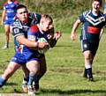 GOTCHA . . . Hollinwood's Tom Wilson (left) grabs an Ossett player as he makes a break in the Pennine League clash
