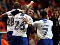 GET IN . . . Peter Clarke (No. 26) gets a hug from manager Stephen Robinson after scoring Athletic's equaliser against Charlton at The Valley last night