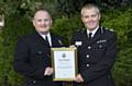 PROUD moment . . . PC Lee Cullen, left, gets his commendation from DCC Ian Pilling