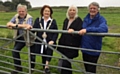 ALL SMILES: Left to right, Councillor Robert Knotts, Councillor Pam Byrne, chair of Saddleworth parish council, Joan Sykes, chair of Scouthead and Austerlands Community Group, and David Needham, secretary of the Scouthead and Austerlands Whit Friday Brass Band Contest Committee
