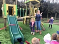 Billie Taylor cutting the ribbon, with Miss Jenkinson, reception teacher