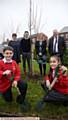 TREE planting . . . Jack Ogden (10) and Aaliya Qaziy (10) with, from left, deputy head Lizzie Egan-Walsh, deputy head Rob Hollinsworth, Helen Rowland, chief executive of Focus Trust and head teacher Nigel Fowler