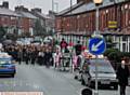 MOURNERS gather behind horse-drawn carriages on Copsterhill Road yesterday
