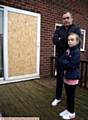 LEE Kinghorn and daughter Evie outside their shattered patio window.