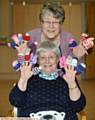 Doreen Hopwood, top, and Anne Ashton with some of the mini hats