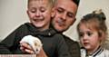 Fang the hamster back in the hands of his family, Zac, Pixie-Belle and Andy Sykes