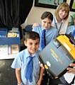 Hand on Heart supplied a defibrillator for Holy Rosary RC Primary School in 2015 thanks to fundraiser Paul Moss. L-R Ethan Moss (9), Elysia Kay - Davies (10), head teacher Barbara Morris and Hamza Ishtiaq (11).