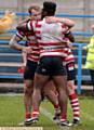 UP AND RUNNING: Danny Langtree gets a hug after scoring Oldham's opening try