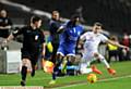 TOUCH AND GO...new signing Tope Obadeyi attempts to skip beyond an MK Dons challenge. PICTURES by ALAN HOWARTH