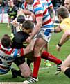 Oldham Rougheds V Rochdale Hornets, match played at the Spotland ground, Rochdale. Oldham player,(green strip), Jorden Walne, is held up from scoring a try by the Rochdale players.