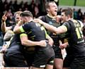 Oldham Rougheds V Rochdale Hornets, match played at the Spotland ground, Rochdale. Oldham player,(green strip), Oldham team members celebrate, Michael Ward's, all important try during the second half of the game..
