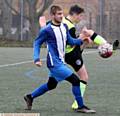 GETTING STUCK IN . . . Hollinwood's Volodohyr Sheludchenko (blue strip). Pictured (inset) is Abel Tsegay whipping in a cross. 