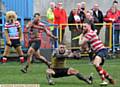 GET AWAY . . . Danny Grimshaw dumps his Haydock opponent to the ground on his way in to score 