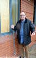 REV. Arthur Janes holding a metal bar which was pulled away from the window before it was smashed