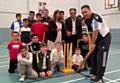 HOWZAT . . . Coach John Abrahams with pupils and Medlock Vale councillors (centre) Yasmin Toor and Ateeque Ur-Rehman at Hathershaw College cricket academy