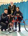 WHEEL fun . . . Laibah Zaid, from Hathershaw College, on the race-running bike with sports development apprentice Adam Morris and the Mayor of Oldham Councillor Derek Heffernan