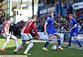 ON THE BALL . . . Athletic' s Ollie Banks is under pressure from the Blades defence with Chris Taylor hugging the touchline.