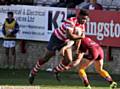 INTO CONTACT . . . Centre Tuoyo Egodo is tackled low by a Bulldogs defender