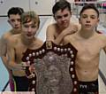 WHAT A SUPER TEAM EFFORT: Brown Shield winners Hulme Grammar are pictured with their big prize. They are (left to right): Jacob Birtles, Tom Sanderson, Tiger Edwards and Tristan Lux
