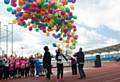 THE balloons go up . . . Oldham's gold medal winning hockey star Nicola White opens the Games