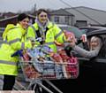 SHOP AND FILM . . . Sophie Kelly and Eleanor Hughes hand out free popcorn and water to Pam Thwaite, from Lees, as she waits for the movie