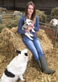 AMY Hough with a newborn lamb at her father's farm