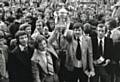 CHAMPIONS . . . a proud moment for Dick Mulvaney, centre right, as he holds the title trophy