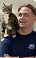 FIRST . . . Nova the first cat to arrive at the centre with animal care assistant Kane Mills