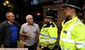 SATURDAY night out . . . David Rolands (left) and Clive Holt talking with Uppermill police officers S/Sgt Kris Curbley (left) and PC James Shillcock