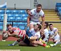 DETERMINATION: Oldham's Adam Clay reaches out to score the second of his hat-trick of tries. 