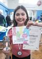 Alicia Custy with her certificate, the Under 10 Suprema Trophy  and her invitation to the Delancy Gigafinal