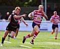 BREAK AWAY . . . Determined George Tyson bursts clear of the Broncos defence to score for Oldham. 