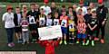 FUNDRAISERS . . . Six-year-old Freddie Farnell, from Springhead FC, holds the cheque aloft with other volunteers, organisers and participants from the 24-hour football marathon
