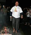 FIRE walker . . . Terry Flanagan, chairman of Mahdlo, Oldham, walks over hot coals for charity