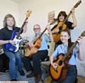 RELAUNCH . . . Muso's owner Pete Clarke, student Ronald Morgan (75), owner Chrissy Clarke, and student Emily Martin (15)
