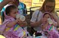 GOTTA lotta bottle . . . twins Lilly (left) and Millie with mum Lauren